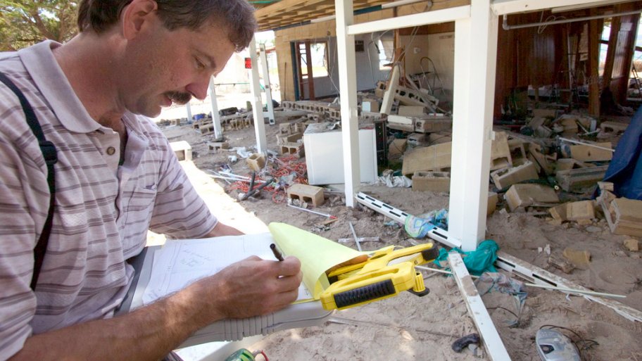 Insurance adjuster assessing hurricane damage